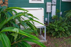 Home backup generator on the side of a house. 