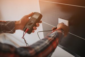 Electrician installing new electrical outlet in a client's home. 