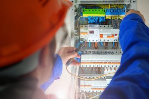 Electrician testing the electrical panel.