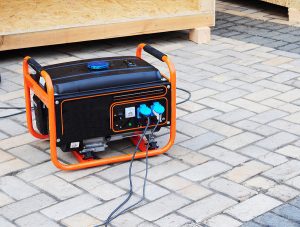 Orange portable generator outside on a concrete patio 