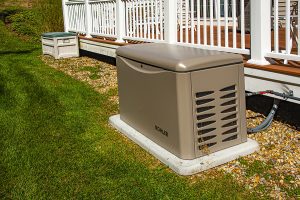 Standby generator placed on a concrete pad outside of a home
