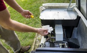 Closeup of a man inspecting a generator. 