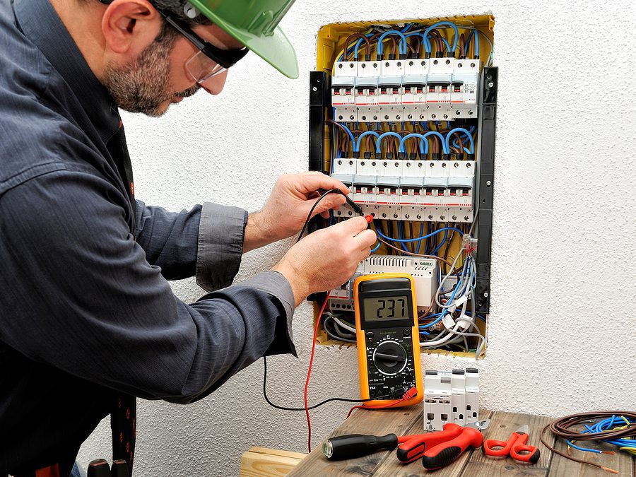 Electrician measuring the voltage of a residential circuit breaker.
